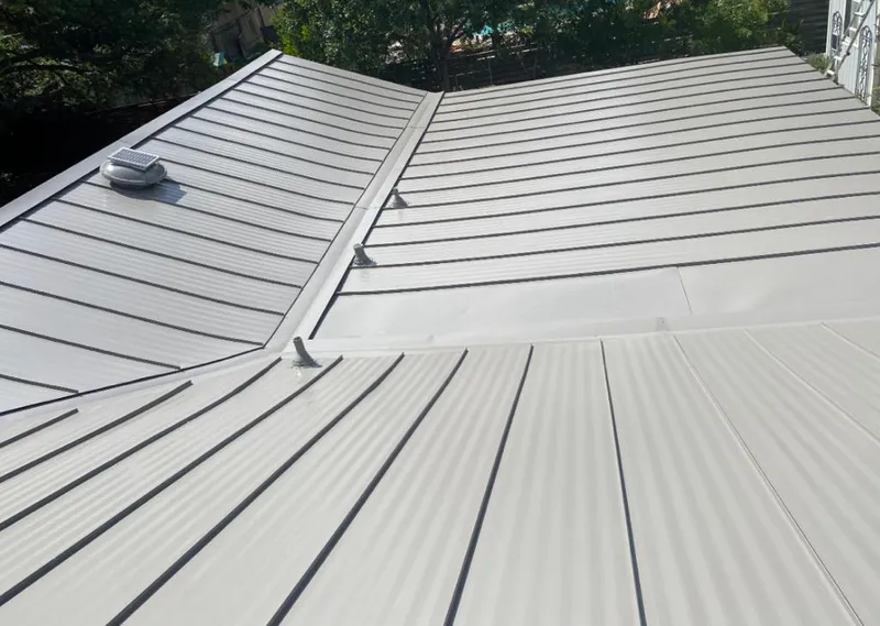 Solar attic fan installed on a metal roof for Roof Ventilation in Lake Hallie